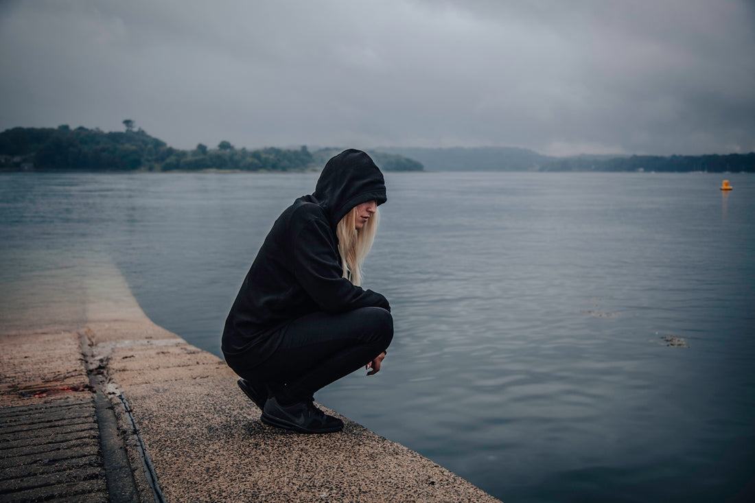 woman almost sitting near seashore
