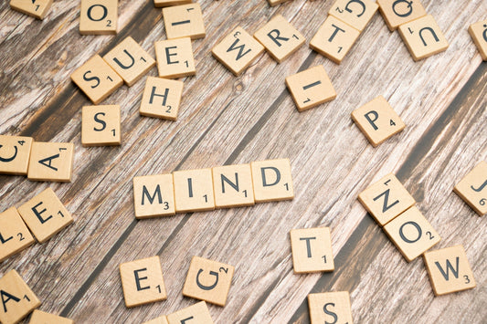 scrabble tiles spelling out the word mind