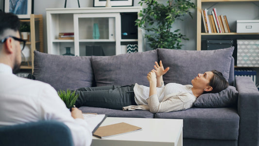 a woman laying on a couch in a living room