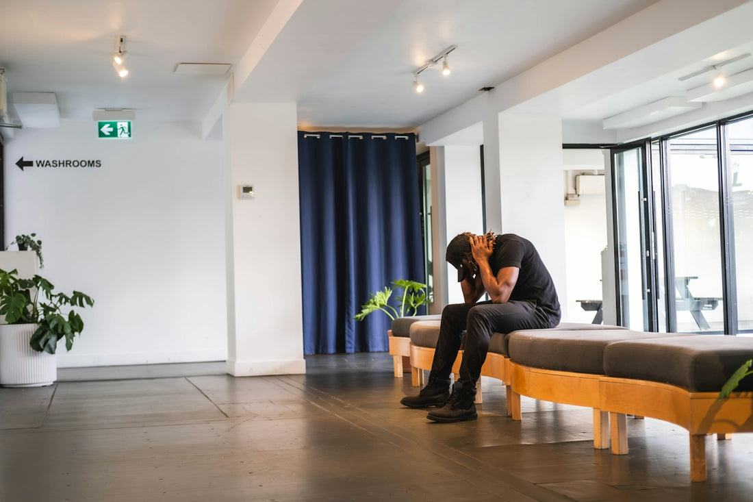 A person sitting on a bench in a room