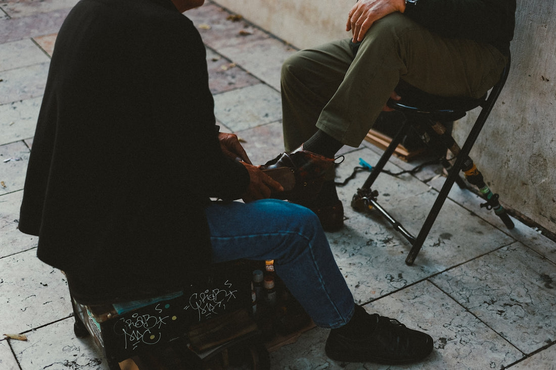 A man sitting on a chair next to a wall